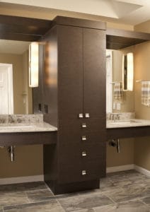 Dual sinks separated by custom cabinets.