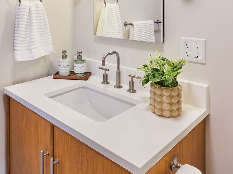 Cedar Hills bath remodel with wood vanity, white solid-surface counter, undermount sink, and brushed nickel faucet