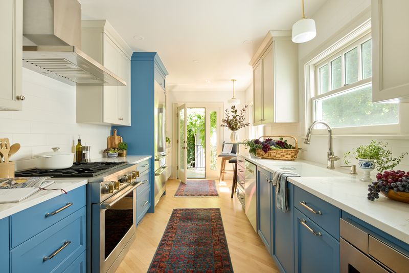 Grant Park galley kitchen remodel with blue base cabinets, cream uppers, quartz counters, and maple floors