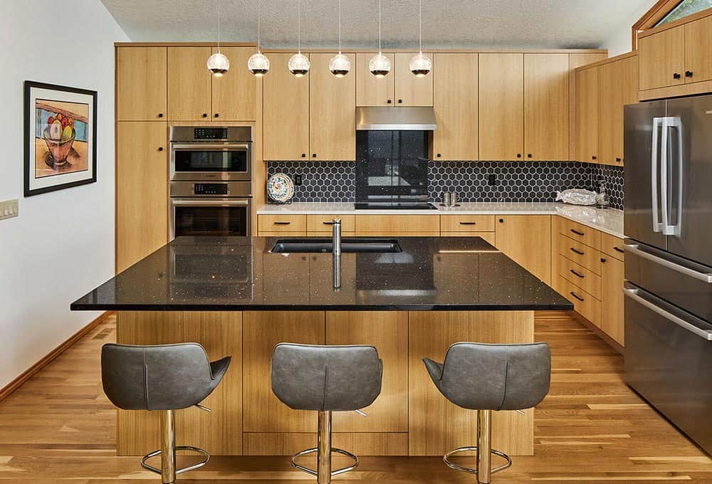 Open concept modern kitchen with bar and custom wood cabinets