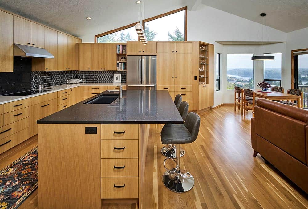Warm open concept kitchen with island and stainless steel appliances