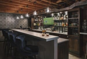 Basement man cave with full bar and television.