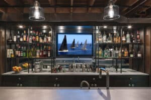 Guest kitchen in basement basement bar with shelving and countertop