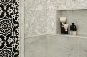 Built-in shower shelf in a granite shower.