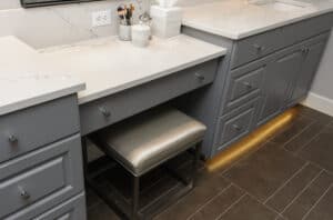 Grey makeup vanity with a small powder room chair