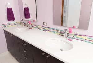 Soft purple with contrasting bright color accents in bathroom