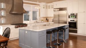 modern kitchen with upgraded stainless steel appliances and blue cabinets.