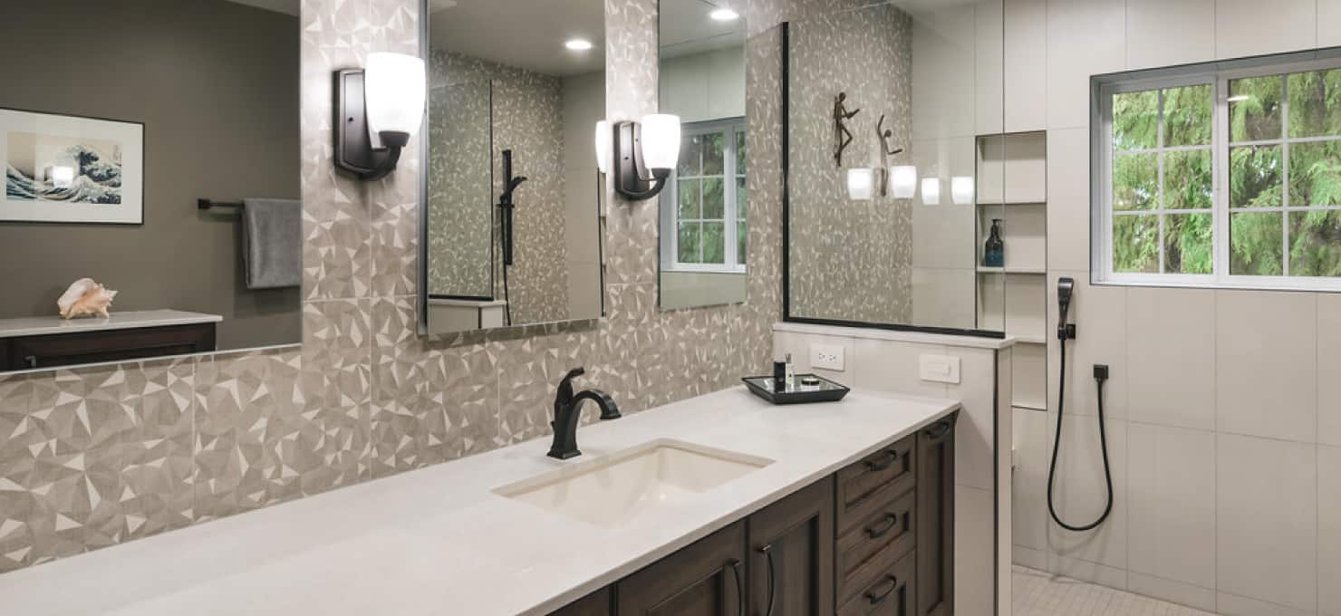 Bathroom vanity with a white countertop, wooden cabinetry below, and a black faucet.
