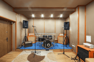 Drum set up in a home music studio in a grage.