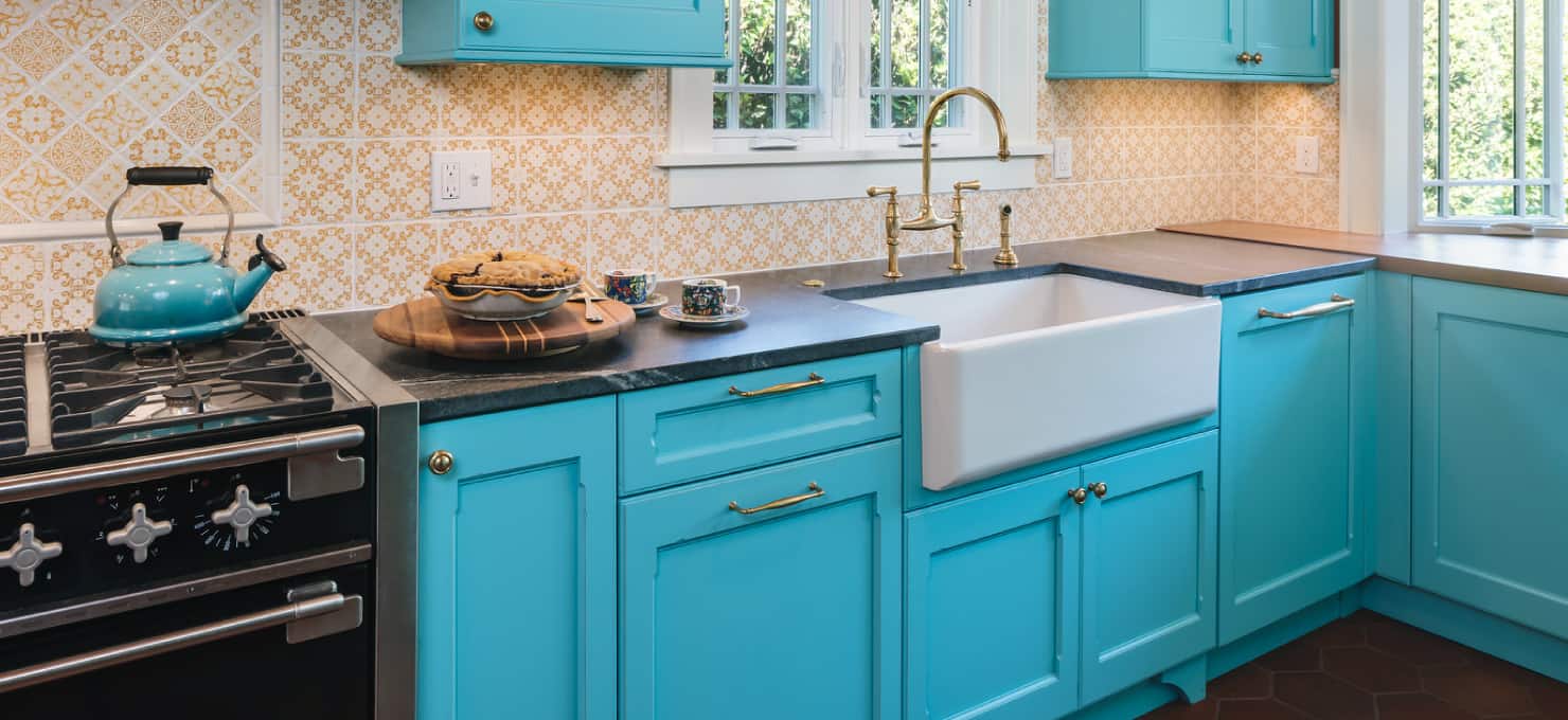 Turquoise colored kitchen cabinets.