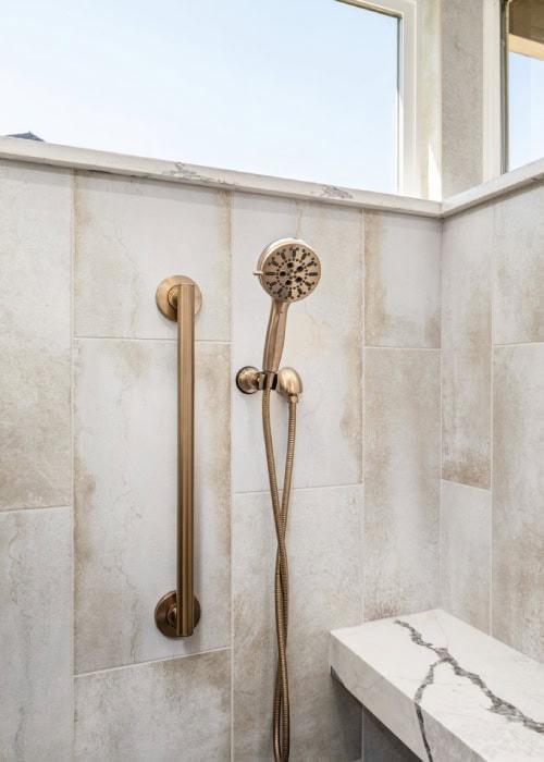 Brass Delta shower head fixture and grab bar.