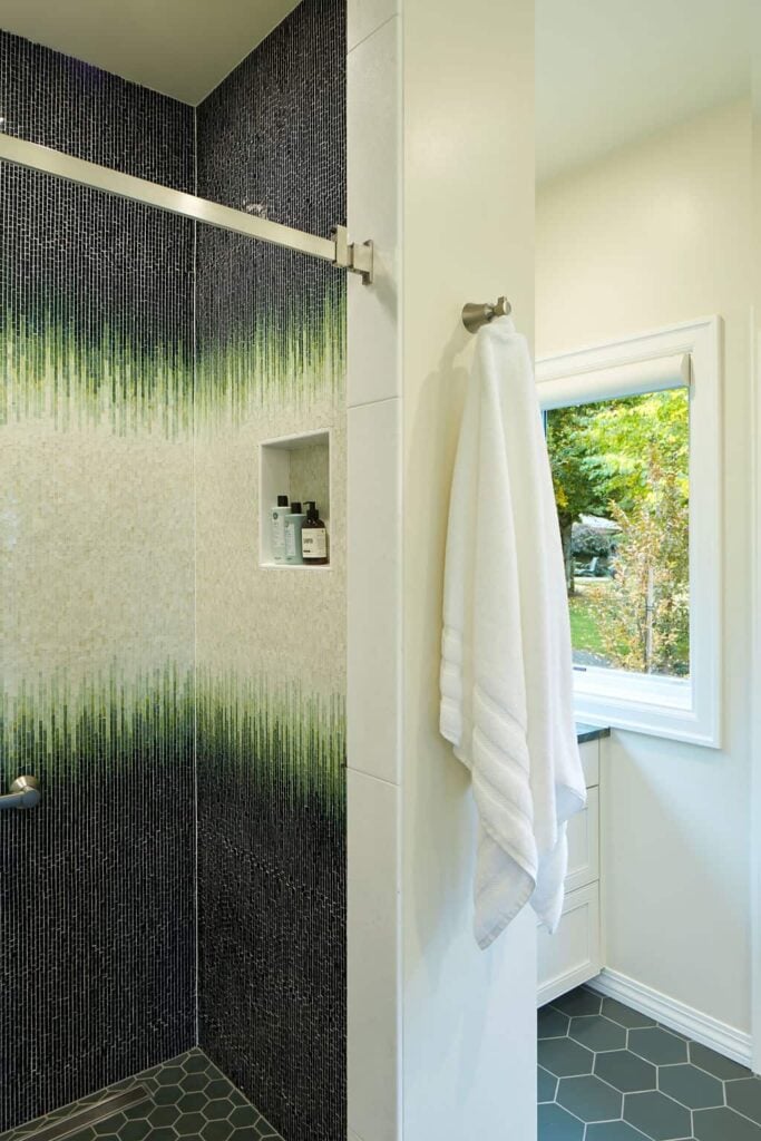 green mosaic shower tile in a garden inspired bathroom design