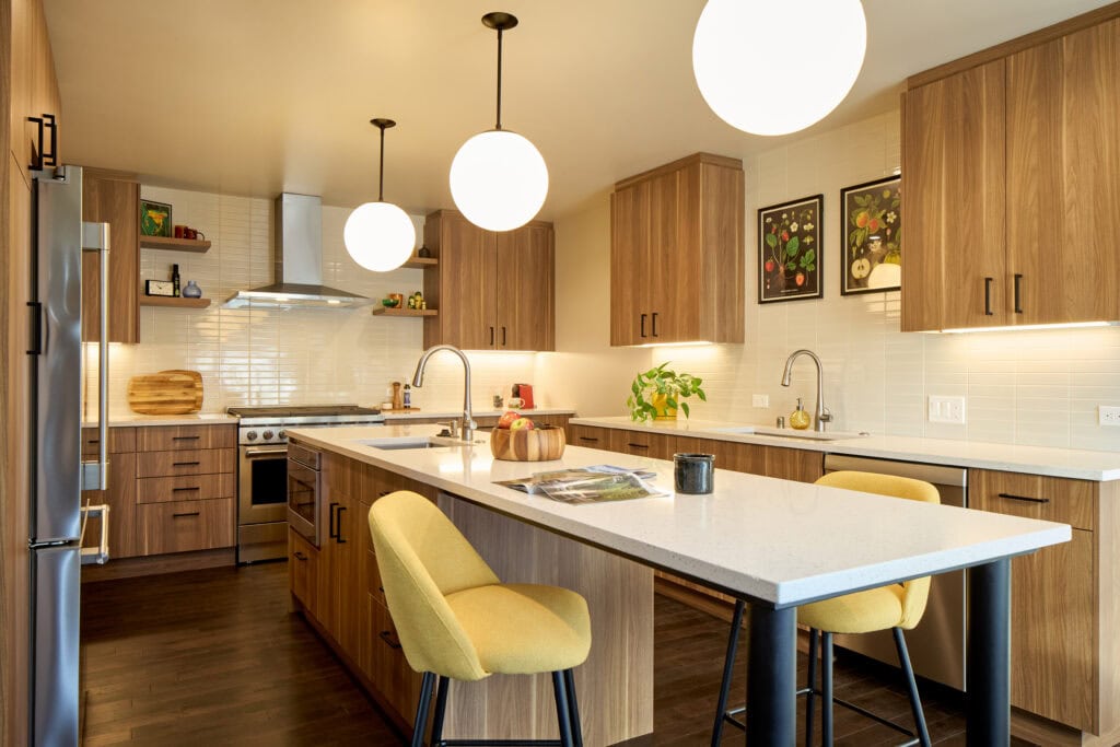 A remodeled kitchen with mid-century inspired design and layered lighting