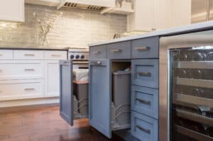 Pull out lower drawer with a trash can inside.