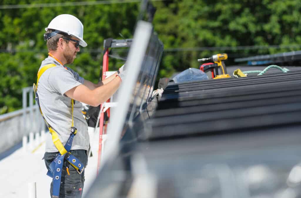 Installer wires up a panel.