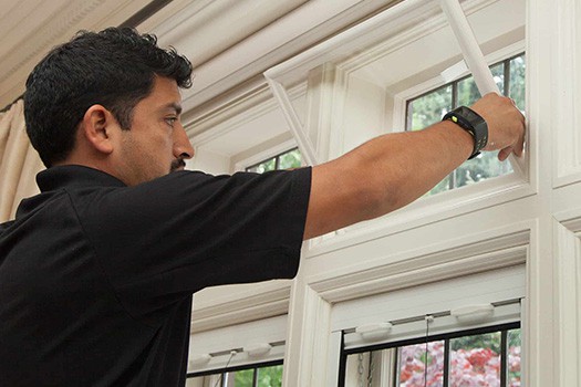 Certified professional checking windows in home for energy efficiency