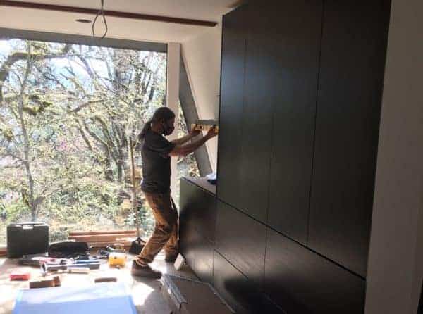 Carpenter practices workplace safety by wearing mask at jobsite