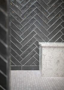 Dark-grey zig zag subway tile backsplash.