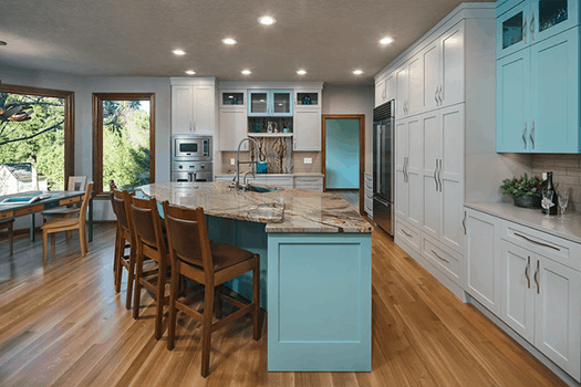 Open kitchen with colorful accents, marble countertops and natural light