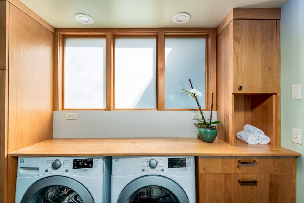 Bright laundry room with ample work space and storage