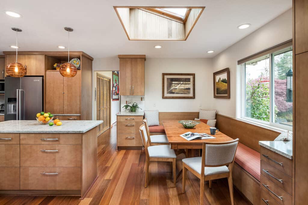 Kitchen with adjacent banquette adds multifunctional space.