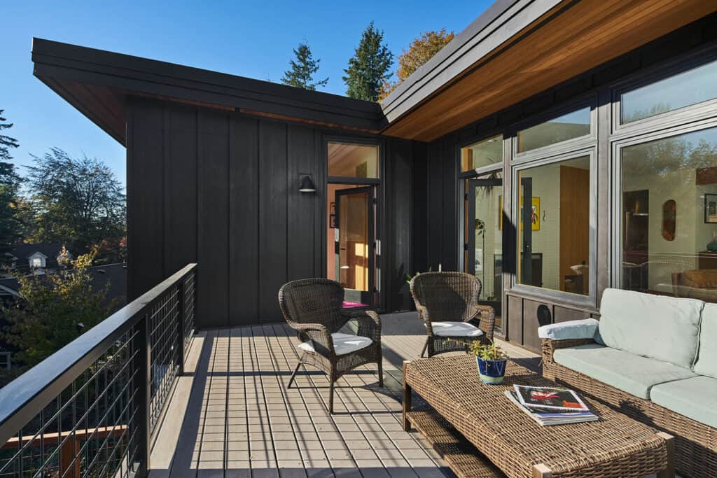 Mid Century two level home with outdoor space featuring wicker furnishings.