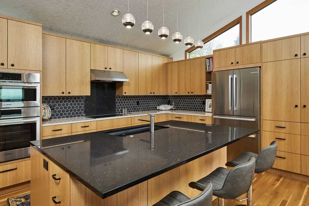 Modern open concept kitchen in Portland with kitchen island and wood cabinets