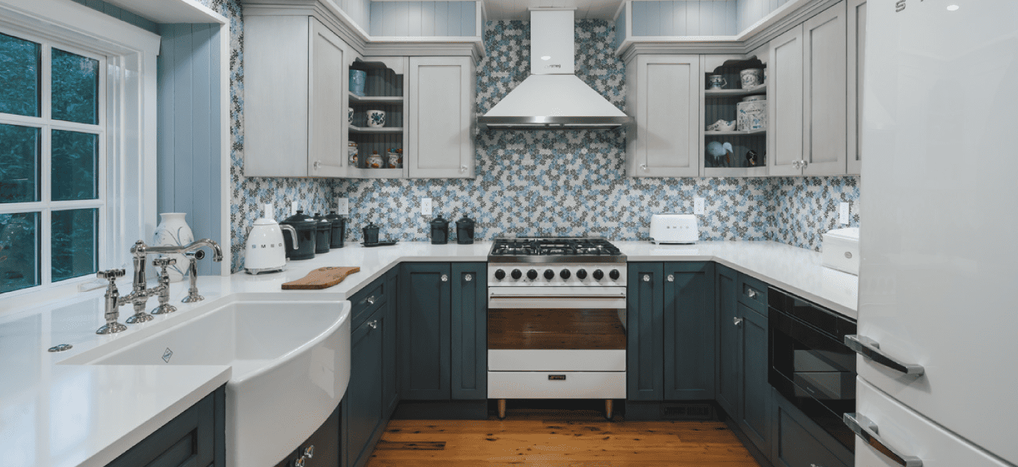 small kitchen with blue backsplash and blue cabinets