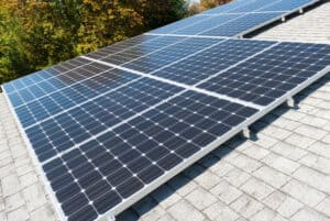 Black solar panels on top of a roof.