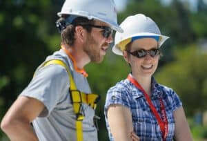 Two Neil Kelly employees in protective construction safety gear