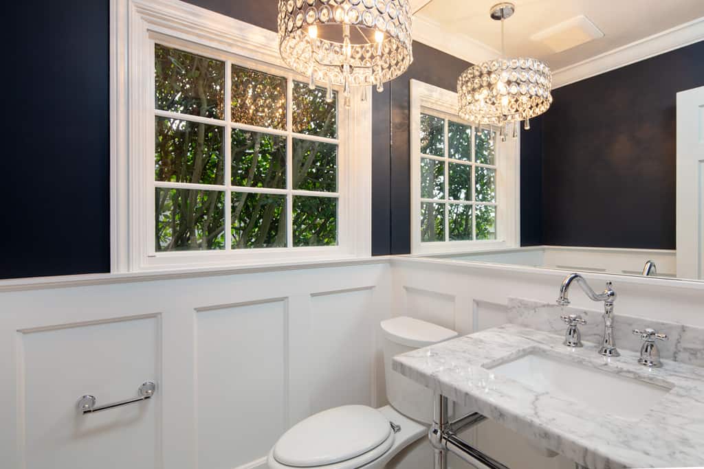Powder room with console sink and pendant light.