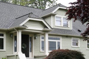 Two-story home in Seattle with grey roofing, and beige house paneling.