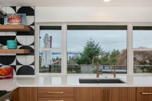 Under mount kitchen sink in a kitchen with white countertops and oak cabinets.