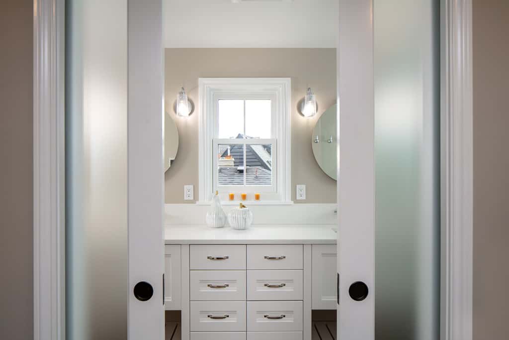 Pocket doors open to reveal primary suite.