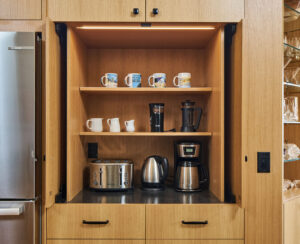 Appliance garage cabinet with small kitchen appliances.