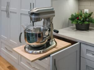 Lower cabinet with a collapsable counter top with a stand mixer on top.