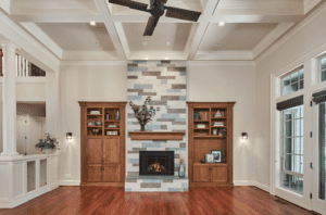 Two wooden doors to each side of a stone fire place and mantle.