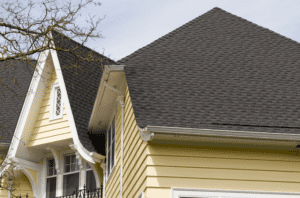 Grey roof of a yellow panel house.