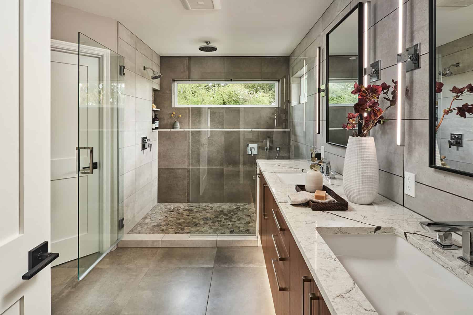 Bathroom with a walk-in shower, porcelain tile flooring and vanity wall, and a dual-sink vanity with PentalQuartz countertops.