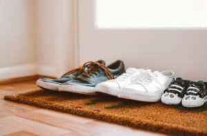 shoes on door mat in front of door.