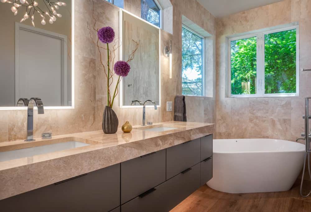 Modern bathroom remodeling project with a floating vanity and a white freestanding bathtub.