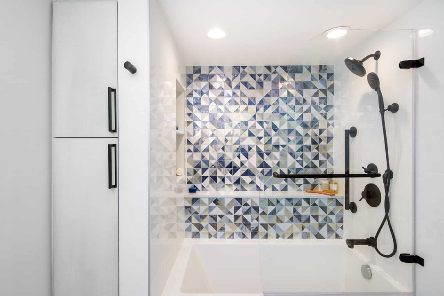 Shower/tub with mosaic shower tile from Oceanside Glass & Tile and black shower fixtures.