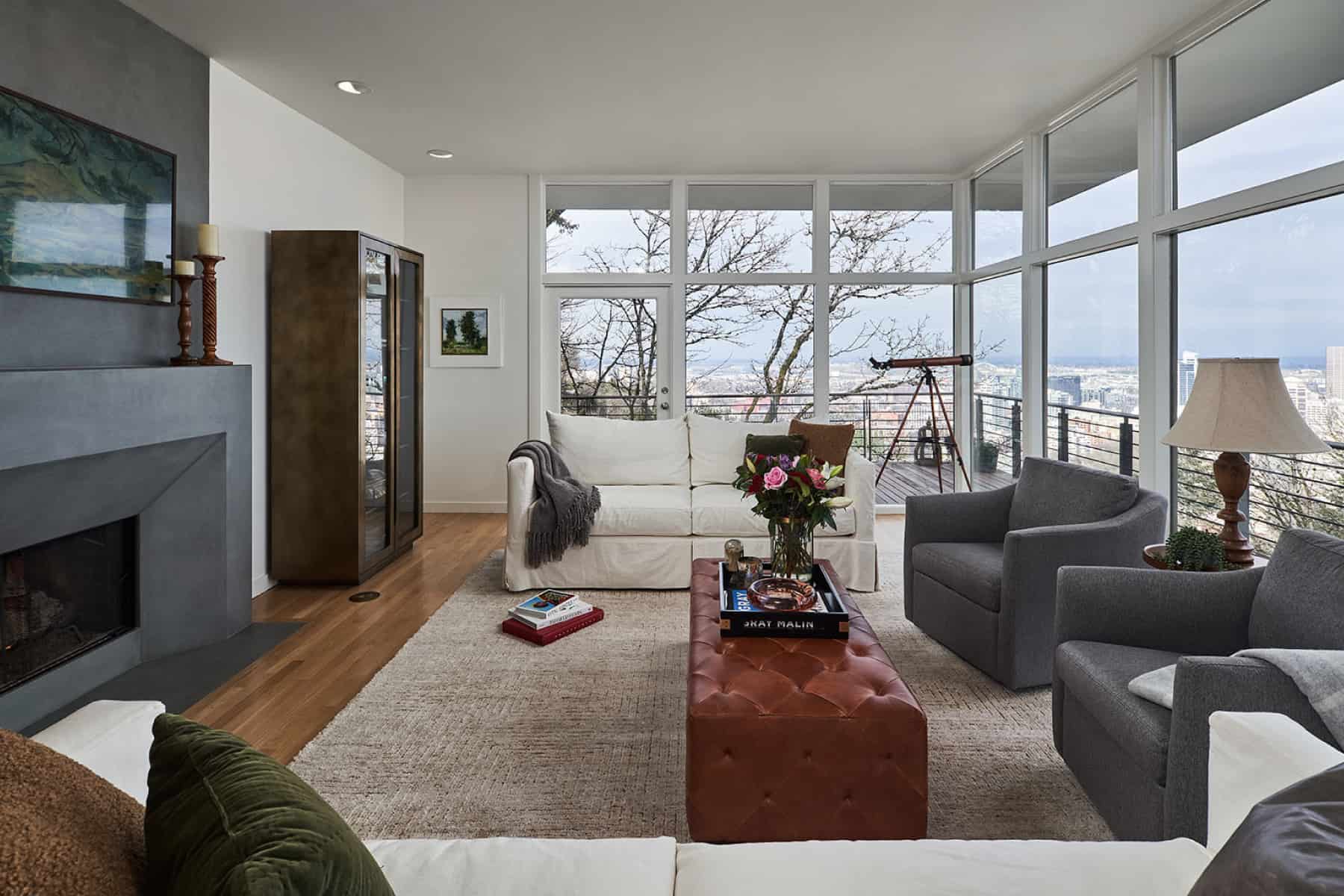Living room with a cement fireplace surround and views of Portland Oregon