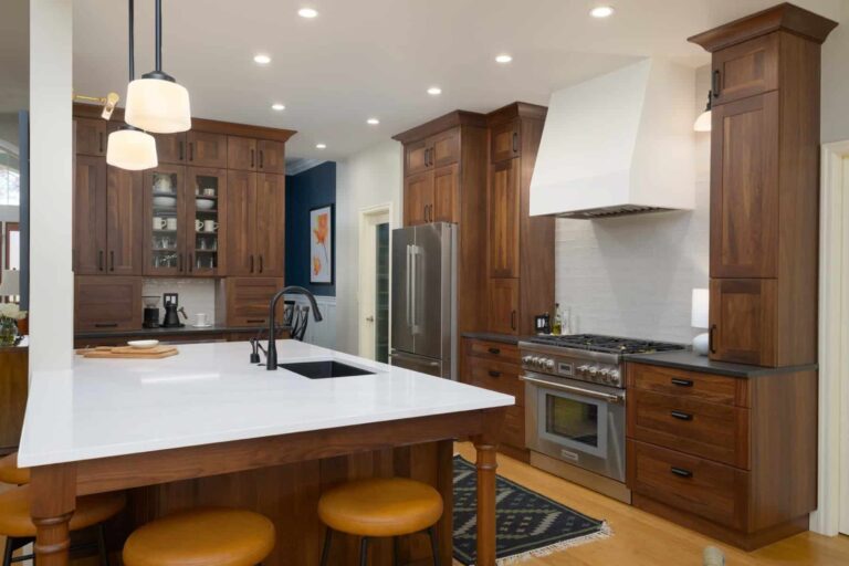 Transitional kitchen with walnut wood finish cabinets and center island.