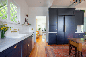 Kitchen with granite countertops, navy cabinetry, and red oak hardwood flooring.