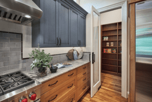 Kitchen with a stainless steel range, marble countertops, and hardwood floors.