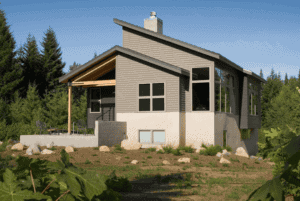 The back of a two story home with grey cedar siding. 