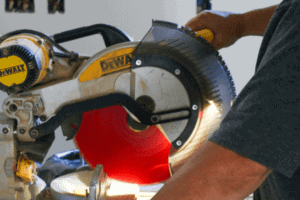 Person using a DeWalt chop saw.