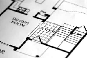 Architectural floor plan showing a dining room, foyer, stairs, and other interior layout details.
