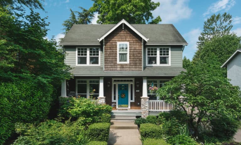 Two-story home with a well-manicured front yard.)